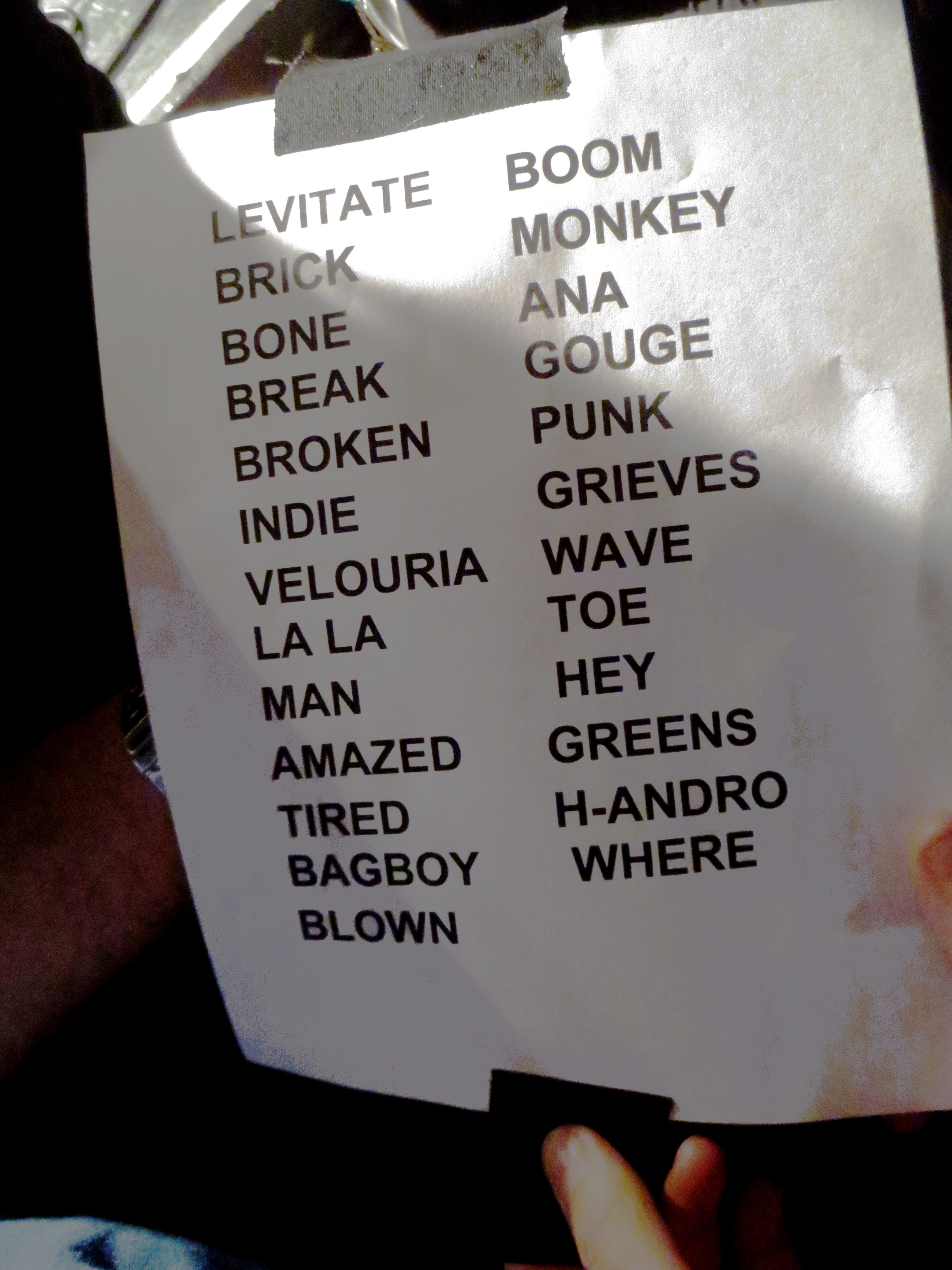 Pixies setlist held after a Bowery Ballroom show, with two columns of bold abbreviated song titles and tape at the top